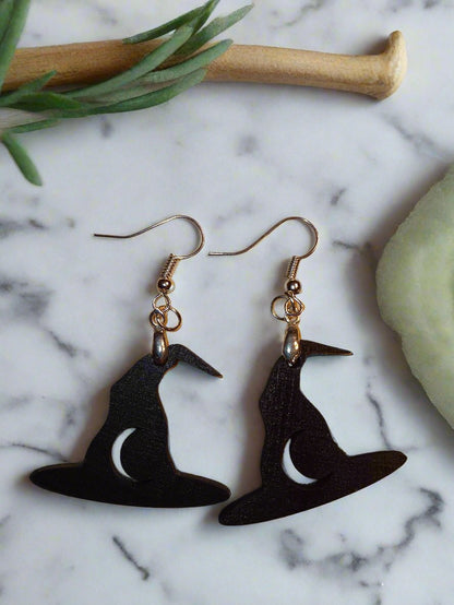 Spooky Earrings featuring black witch hats with crescent moons. Perfect for adding a touch of magic to your Halloween outfit.