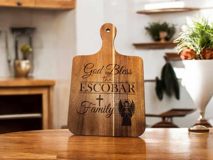 16x10 personalized cutting board with "God Bless the Escobar Family" engraved, displayed in a modern kitchen setting.