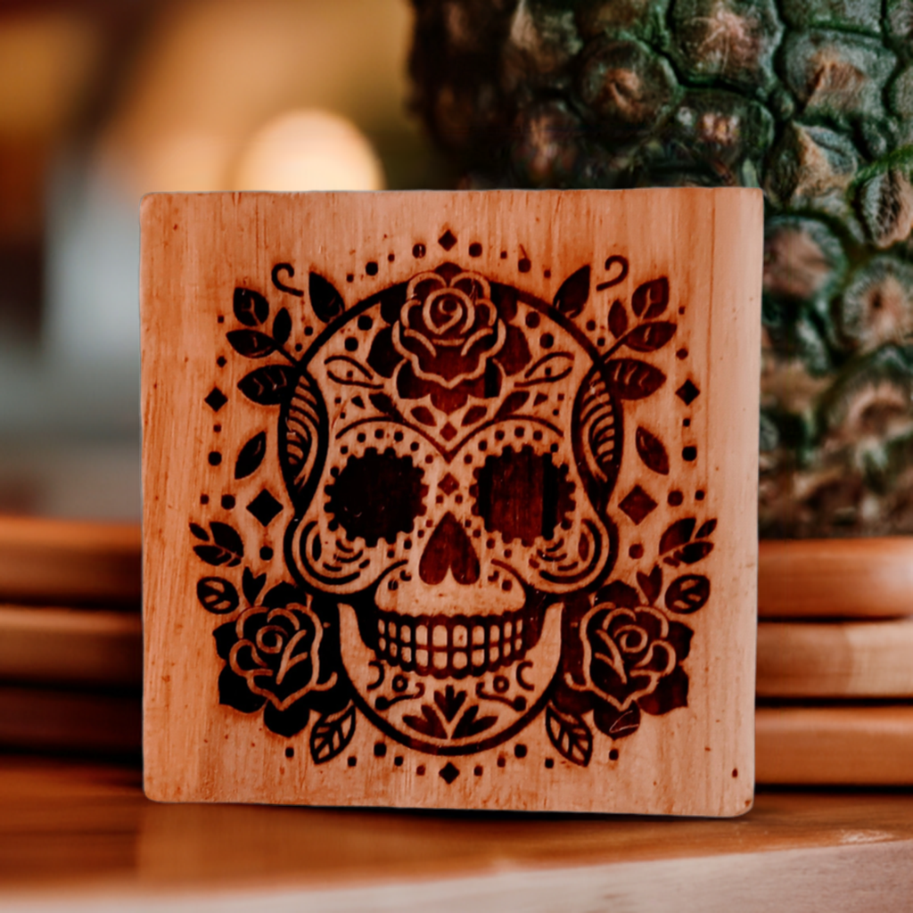 Wooden coaster featuring an intricately carved skull design with floral patterns, part of the Coaster set skulls product page.