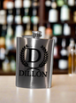 stainless steel flask laser engraved with "Dillon" and a large "D"